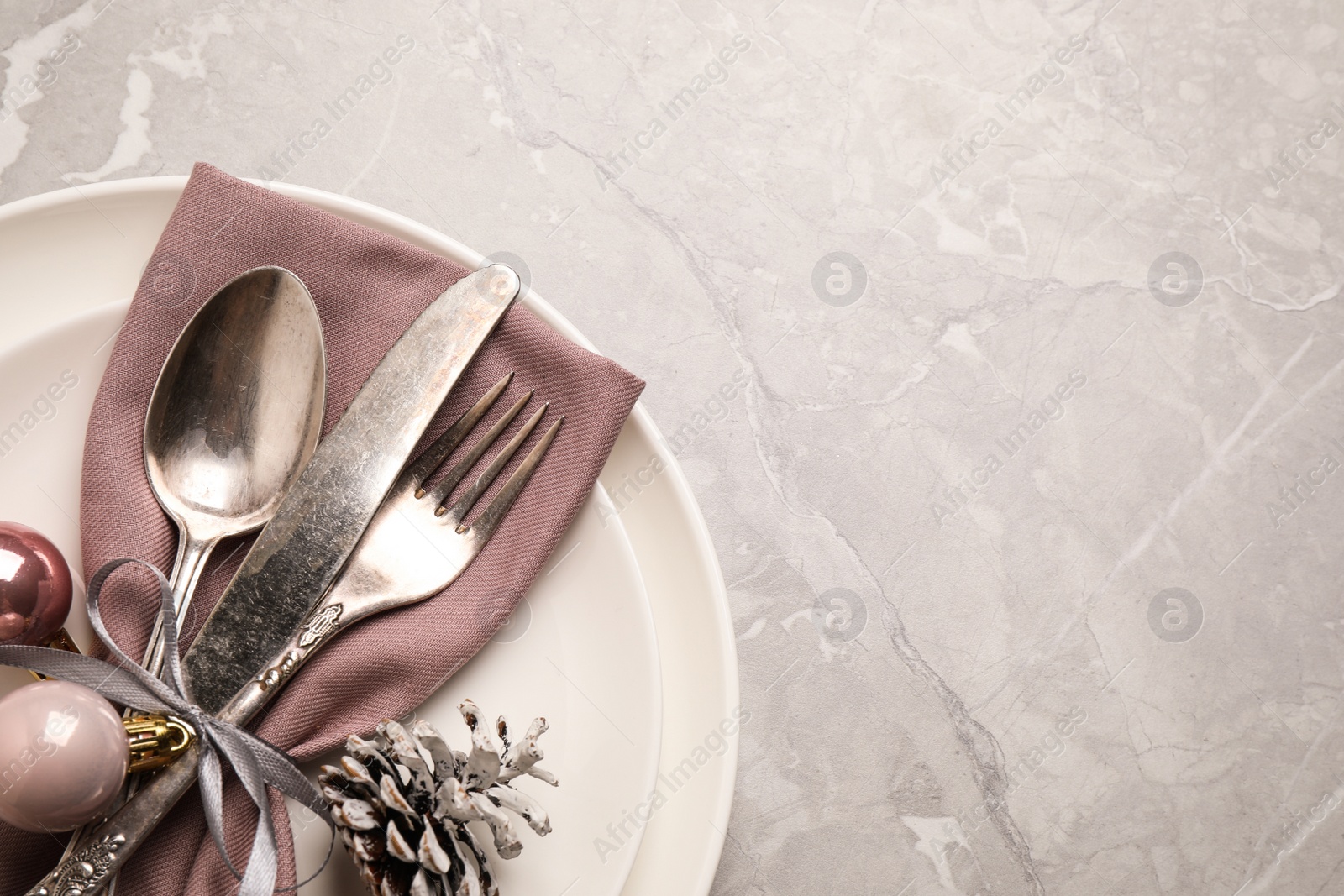 Photo of Beautiful Christmas table setting on light grey marble background, top view. Space for text