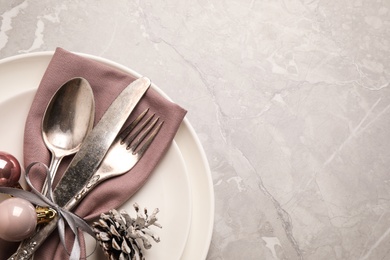 Beautiful Christmas table setting on light grey marble background, top view. Space for text