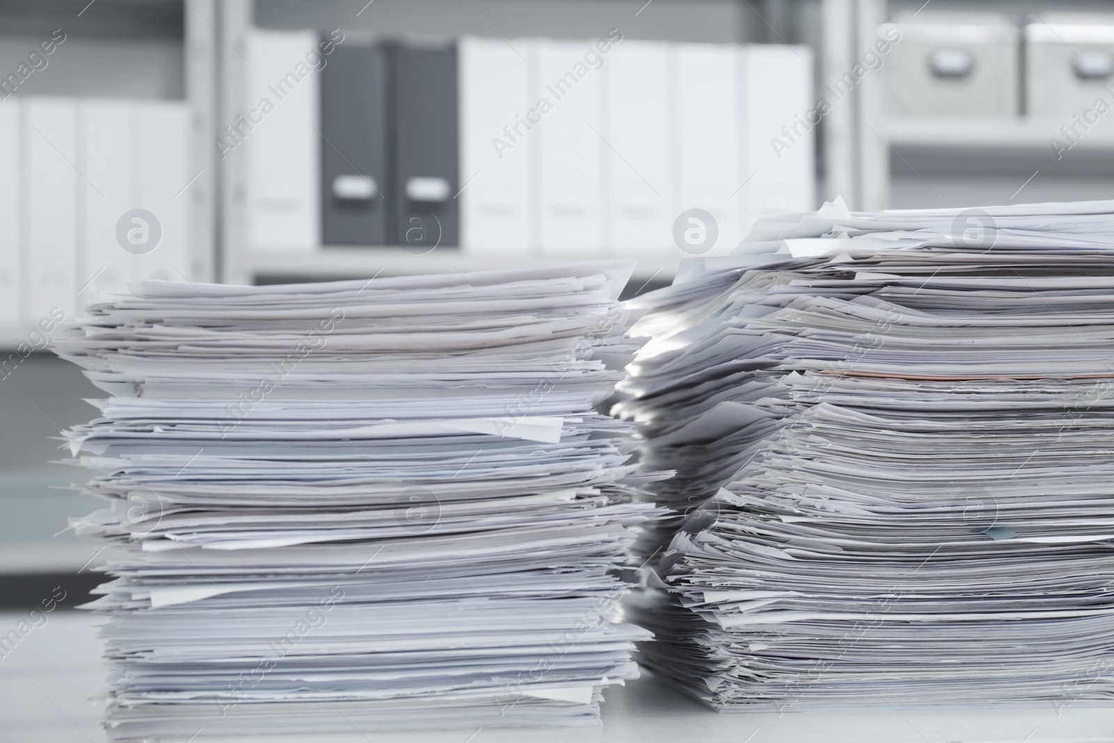 Photo of Stacks of documents on table in office