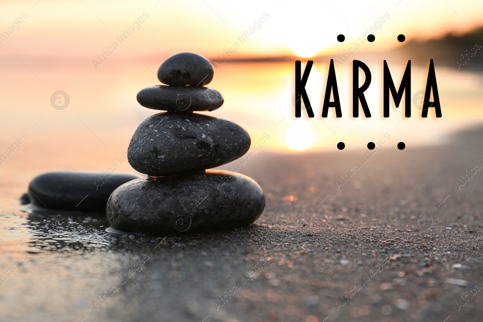 Image of Karma concept. Stones on sand near sea at sunset