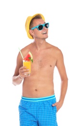 Shirtless man with glass of cocktail on white background