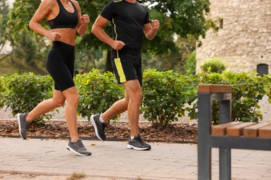 Photo of Healthy lifestyle. Couple running in park, closeup
