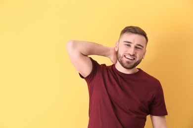 Portrait of smiling young man on color background