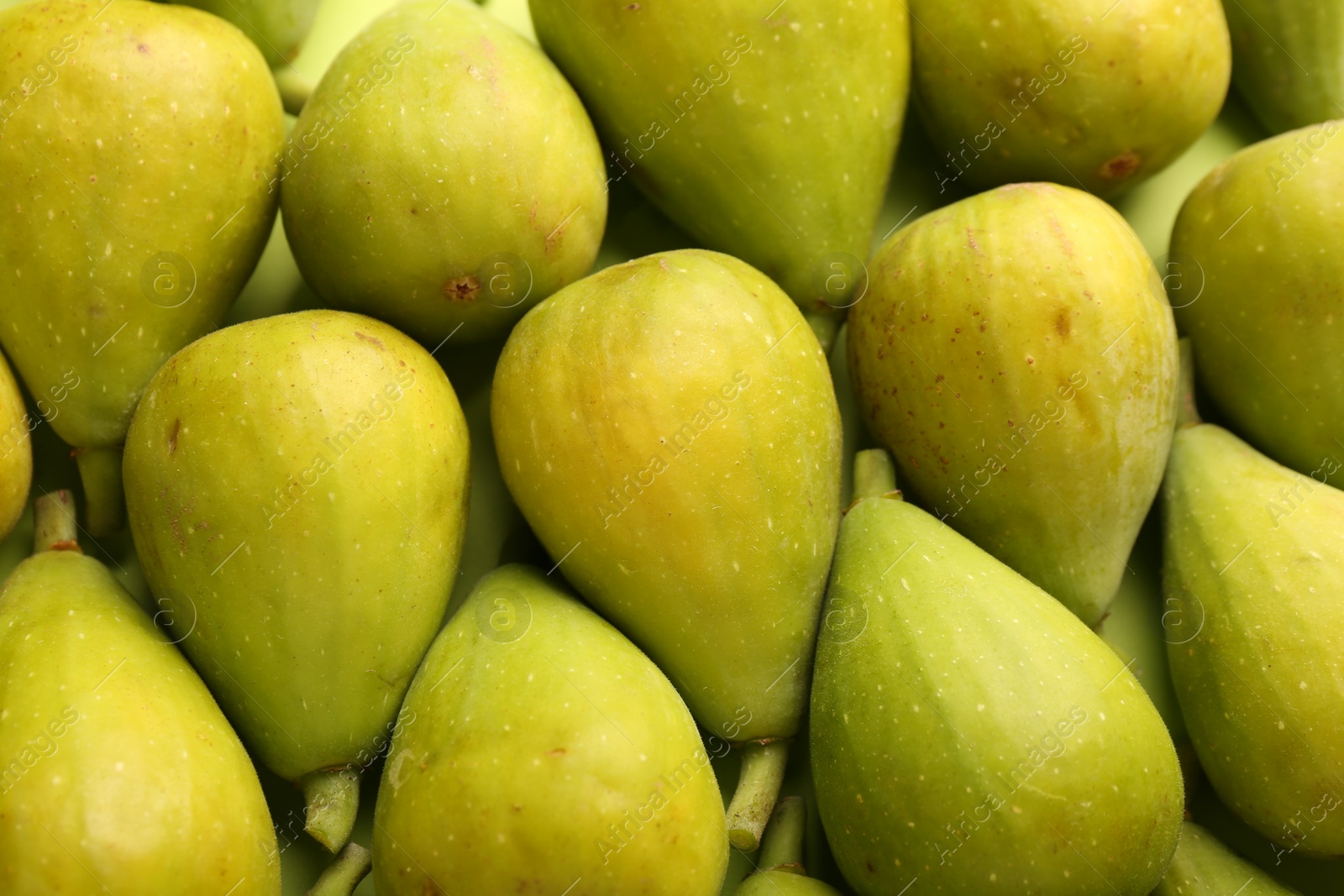 Photo of Many fresh green figs on table, above view