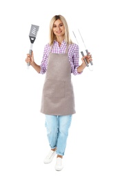 Photo of Woman in apron with barbecue utensils on white background