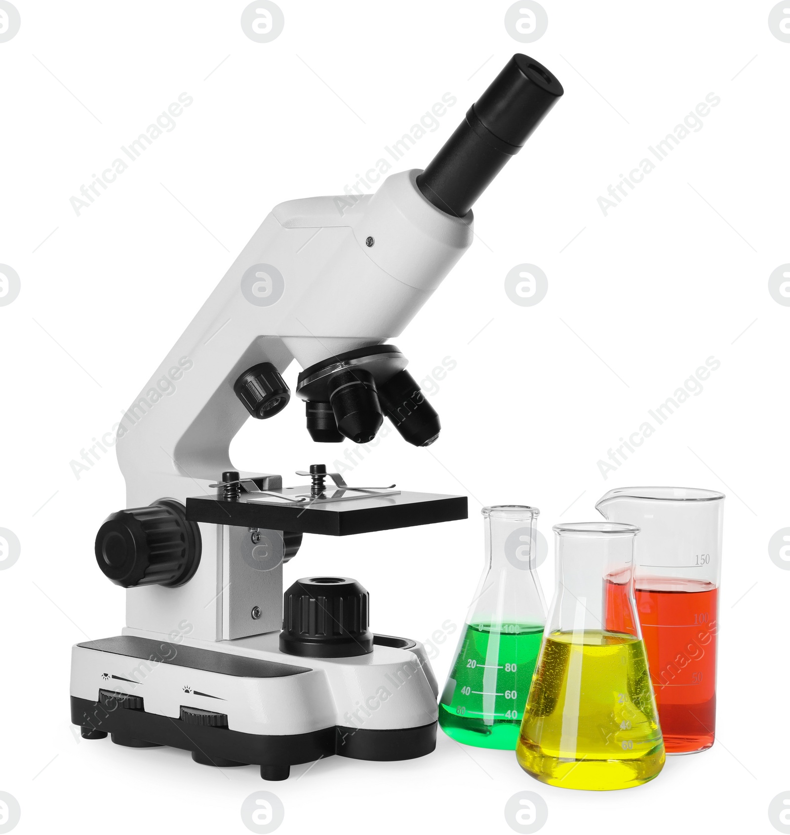 Photo of Laboratory glassware with colorful liquids and microscope isolated on white