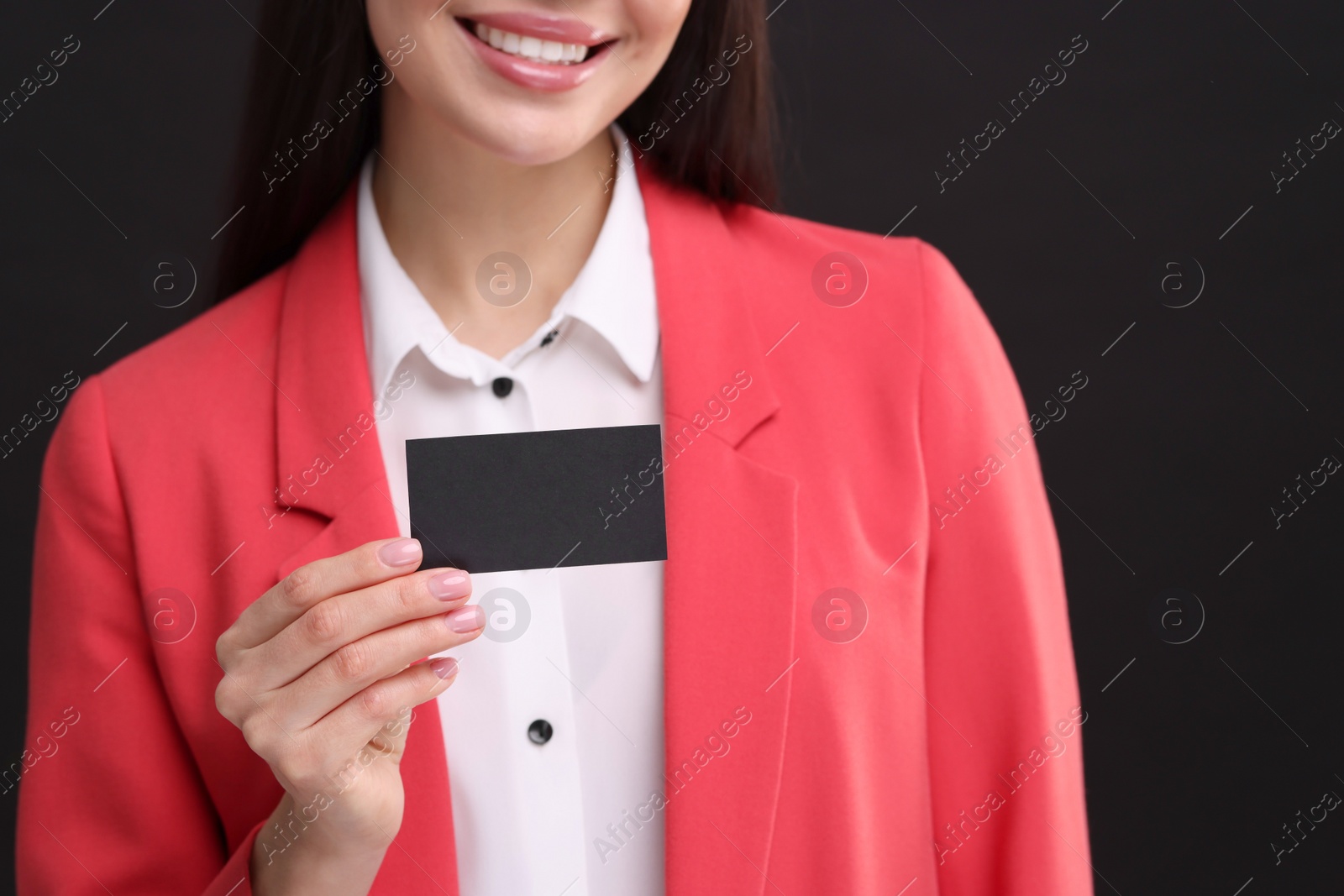 Photo of Woman holding blank business card on black background, closeup. Space for text