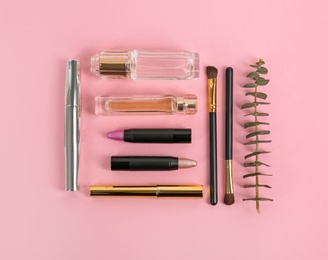 Photo of Flat lay composition with bright lipsticks and accessories on pink background