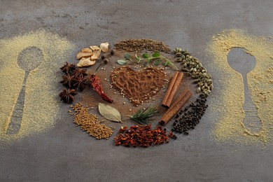 Photo of Different spices and silhouettes of spoons on grey textured table