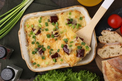 Photo of Tasty sausage casserole served on table, flat lay