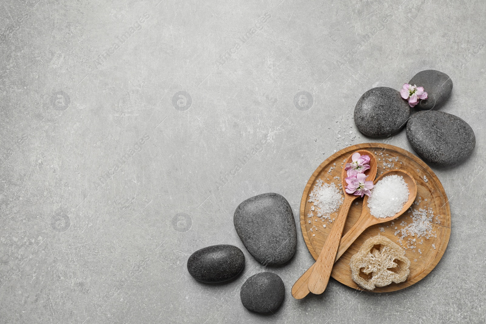 Photo of Flat lay composition with sea salt and spa stones on grey marble table. Space for text