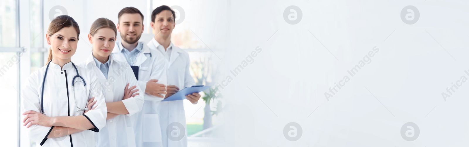 Image of Young doctors wearing uniform in hospital, space for text. Banner design