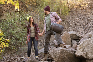 Couple of campers with sleeping bag in wilderness