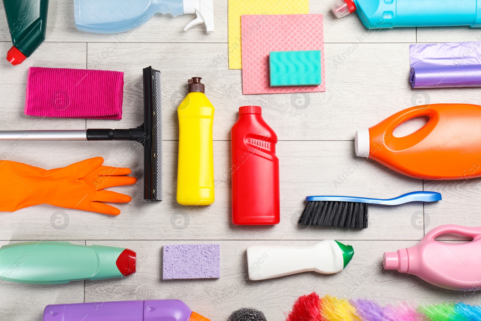 Photo of Flat lay composition with cleaning supplies on wooden background