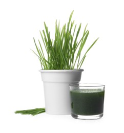 Photo of Wheat grass in pot, glass of green drink and fresh sprouts isolated on white