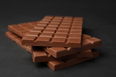 Tasty chocolate bars on grey table, closeup