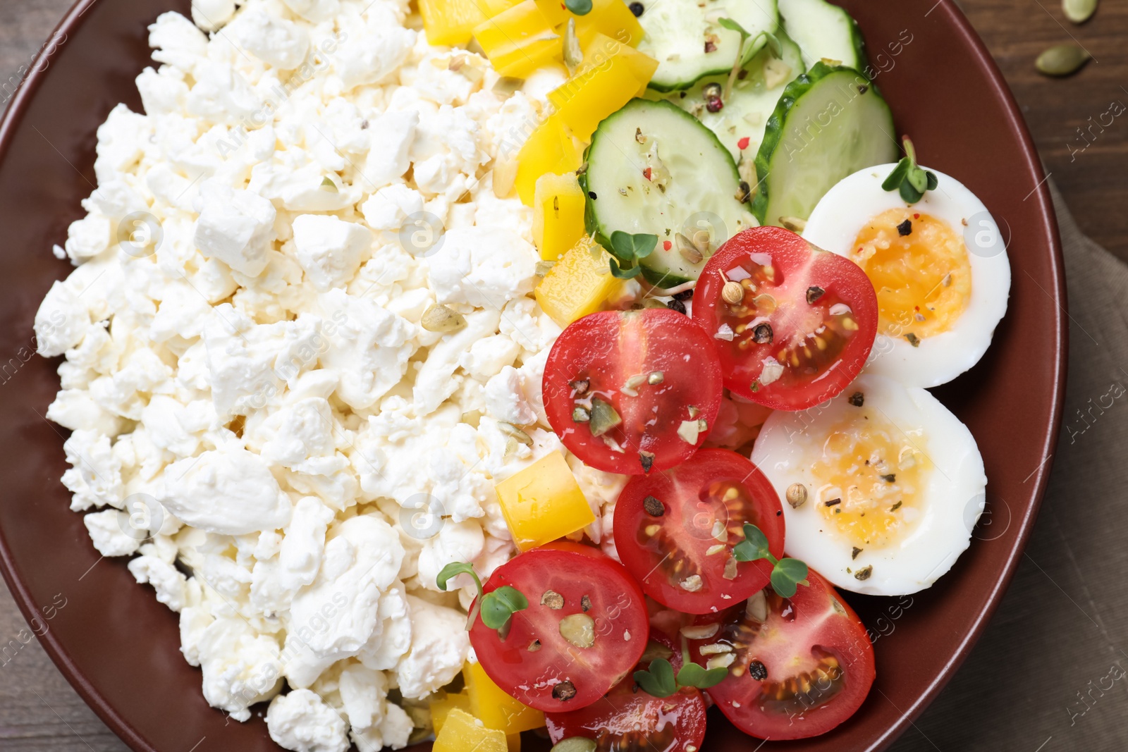 Photo of Delicious cottage cheese with vegetables and boiled egg served for breakfast on table, top view