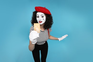 Photo of Funny mine with credit card posing on light blue background