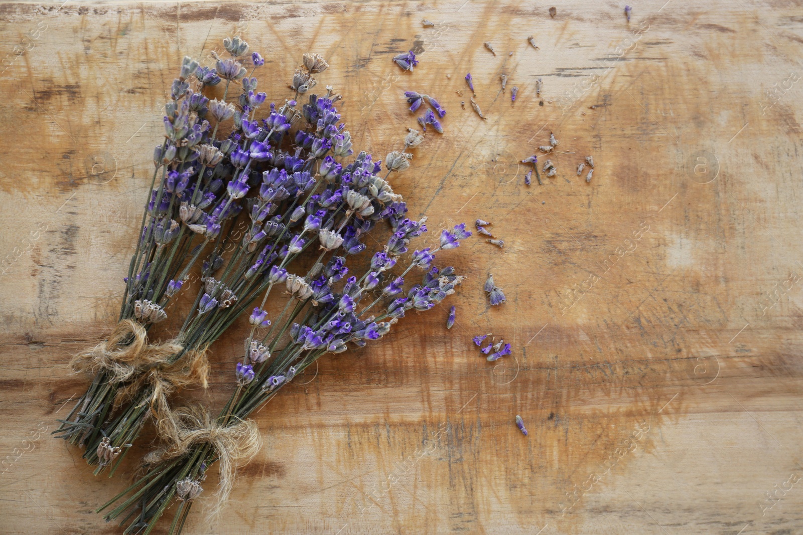 Photo of Bouquets of beautiful lavender flowers on wooden table, flat lay. Space for text