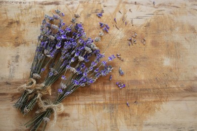 Bouquets of beautiful lavender flowers on wooden table, flat lay. Space for text