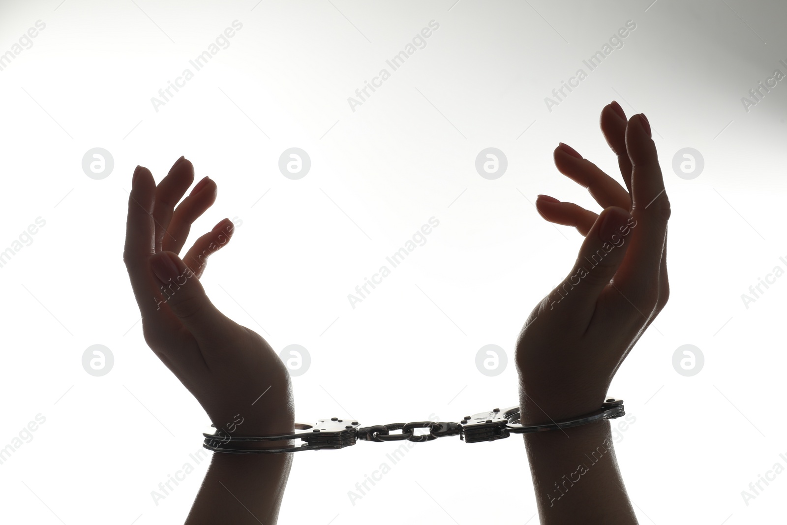 Photo of Freedom concept. Woman with handcuffs on white background, closeup