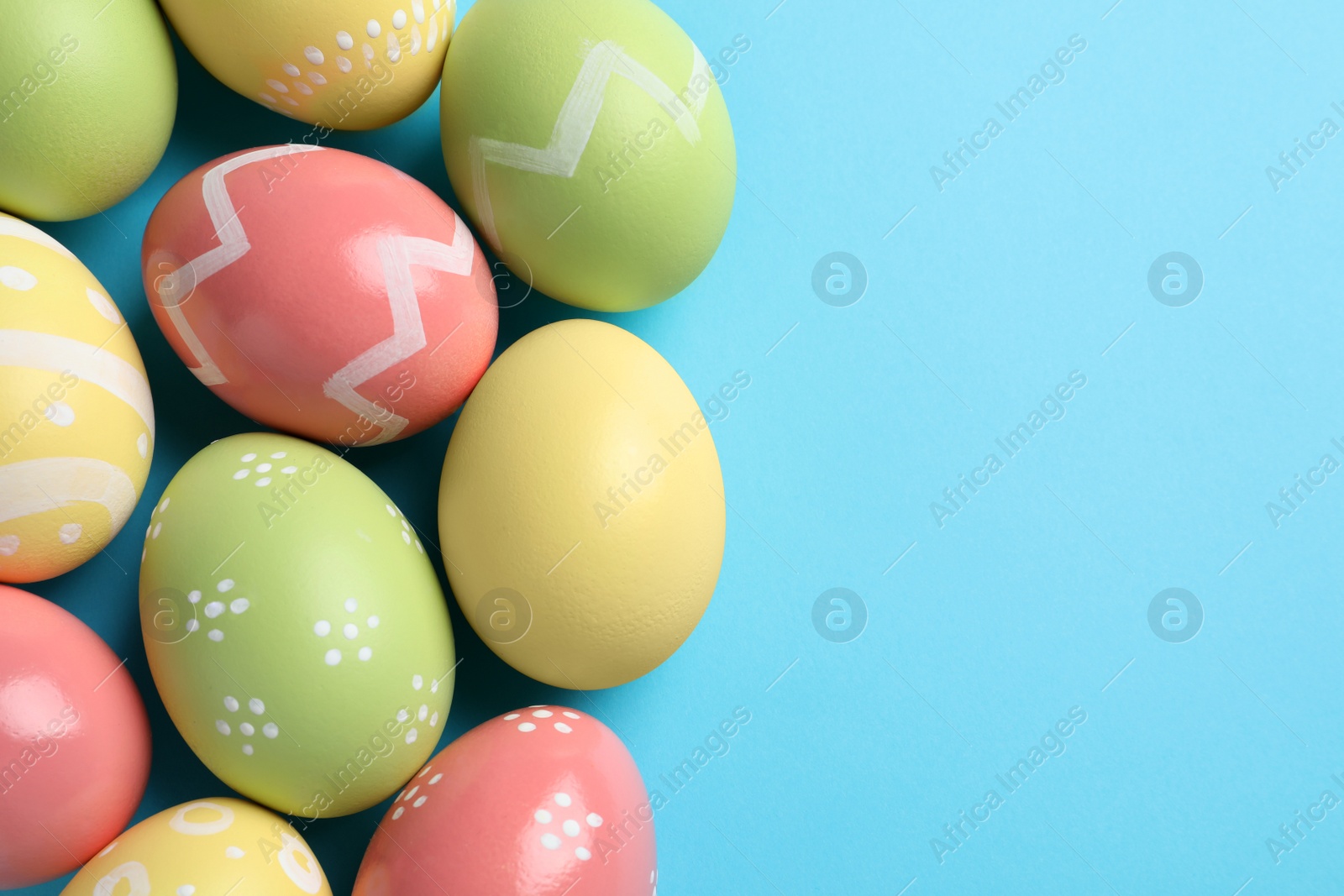 Photo of Beautiful painted Easter eggs on color background, flat lay. Space for text