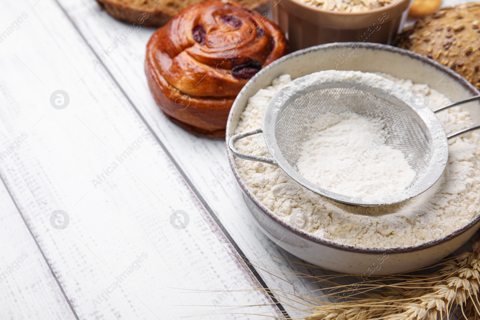 Photo of Different gluten free products on white wooden table, closeup. Space for text