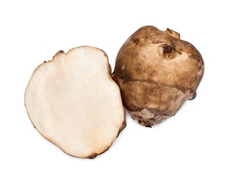 Photo of Whole and cut Jerusalem artichokes isolated on white, top view