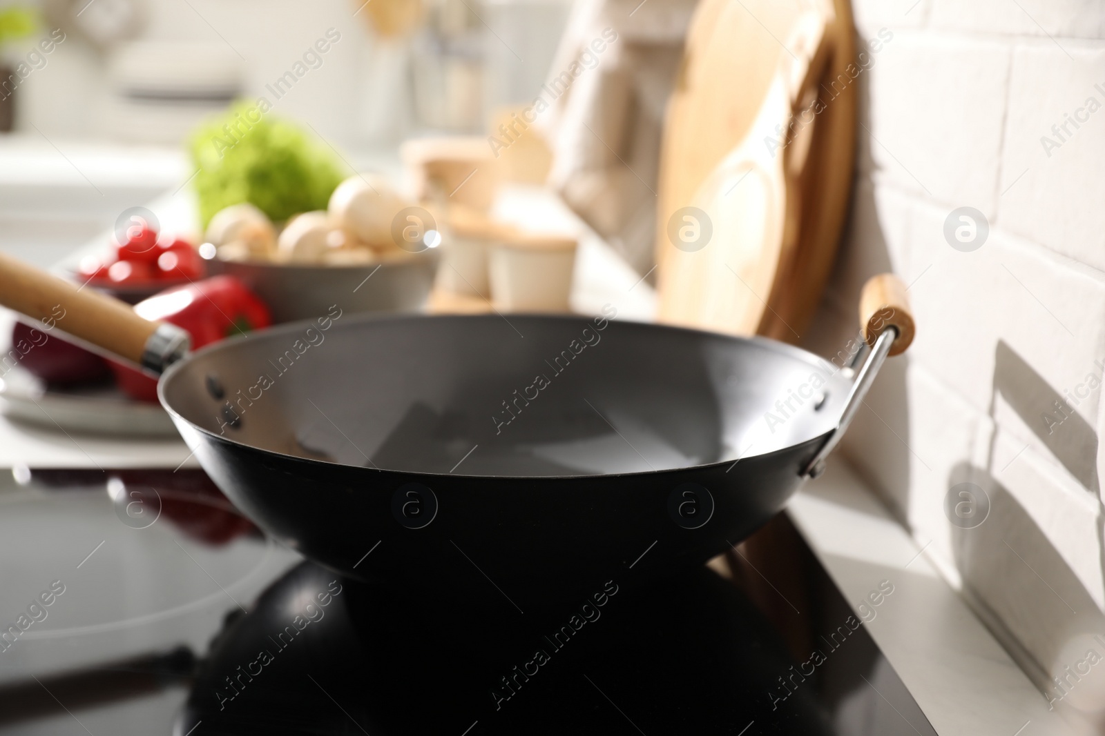 Photo of Frying pan on modern cooktop in kitchen