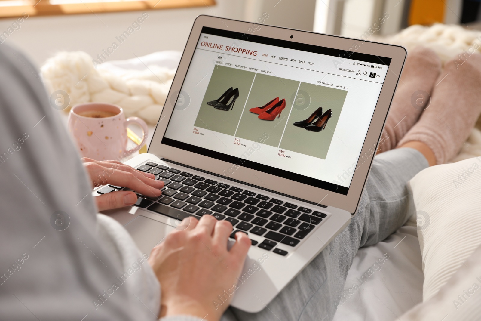 Photo of Woman using laptop for online shopping indoors, closeup