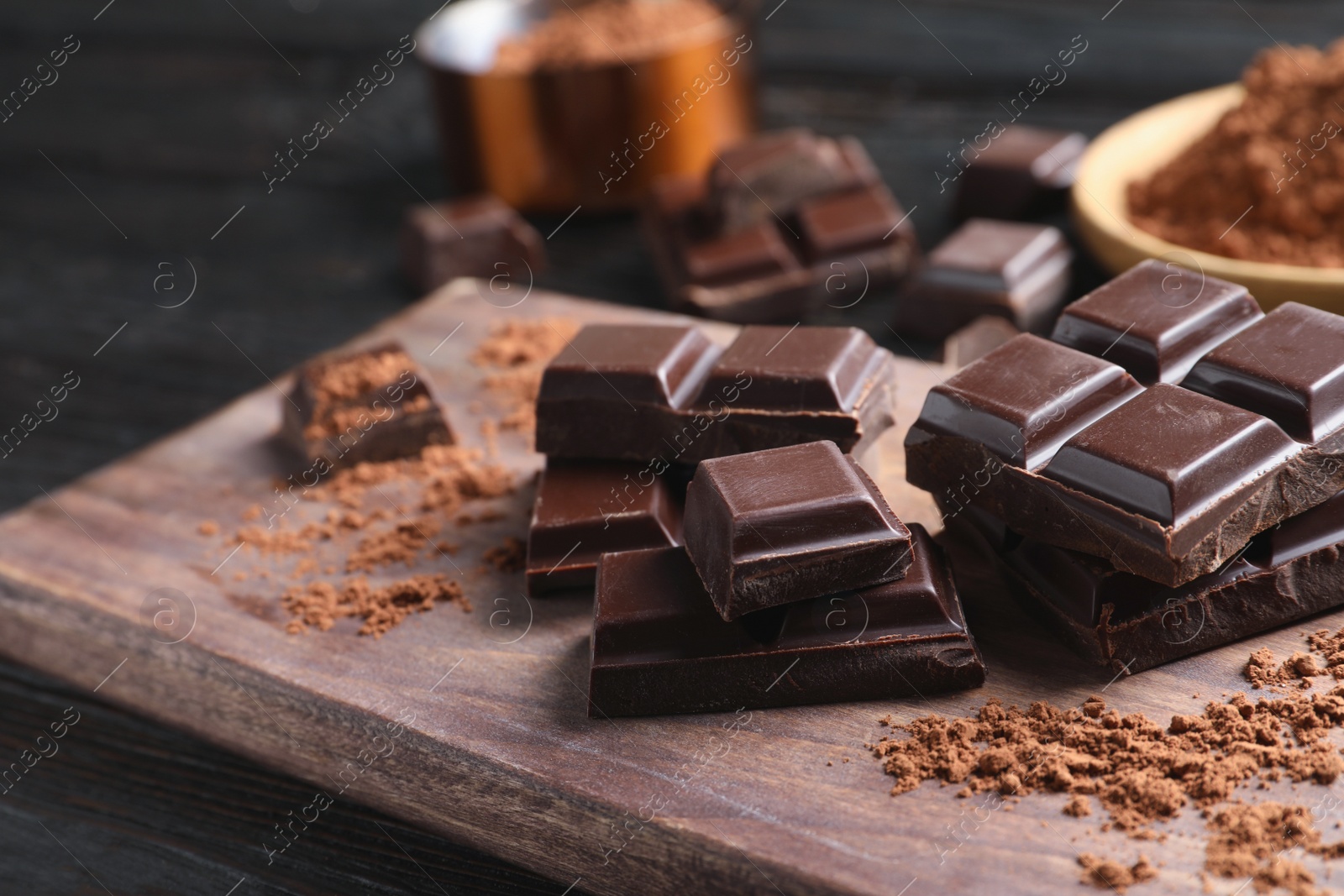 Photo of Pieces of black chocolate on wooden board