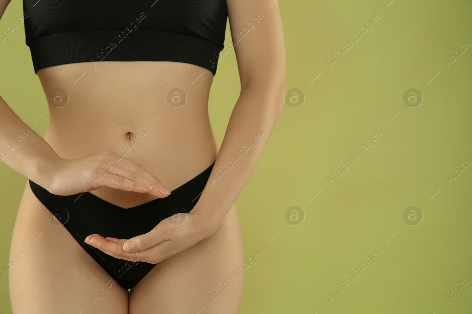 Photo of Gynecology. Woman in underwear on green background, closeup. Space for text