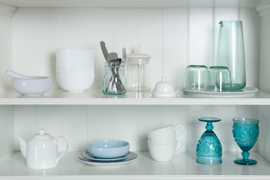 White shelving unit with set of dishware