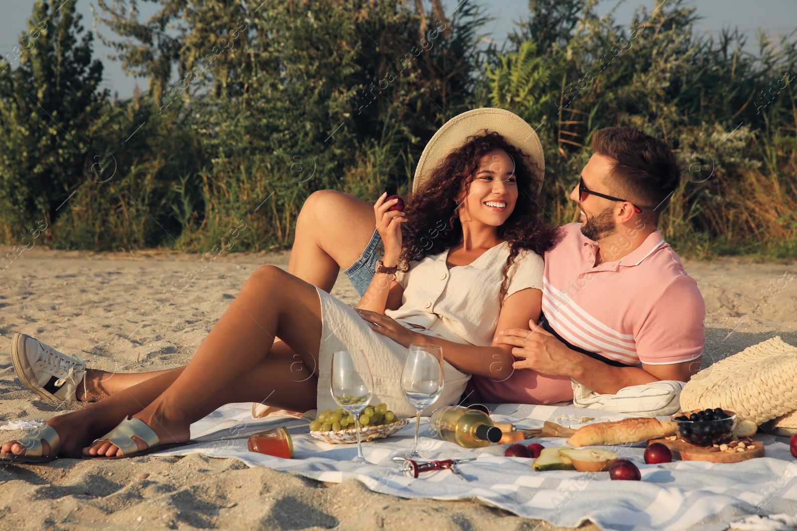 Photo of Lovely couple having picnic outdoors on sunny day