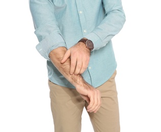 Photo of Young man scratching arm on white background, closeup. Annoying itch