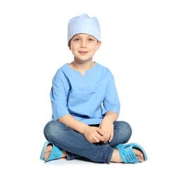 Cute little child in doctor uniform on white background