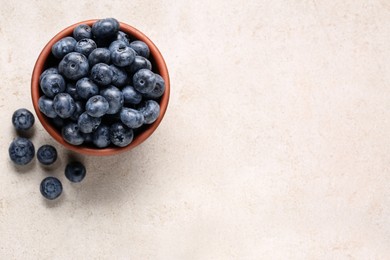 Photo of Tasty fresh blueberries on light table, flat lay. Space for text