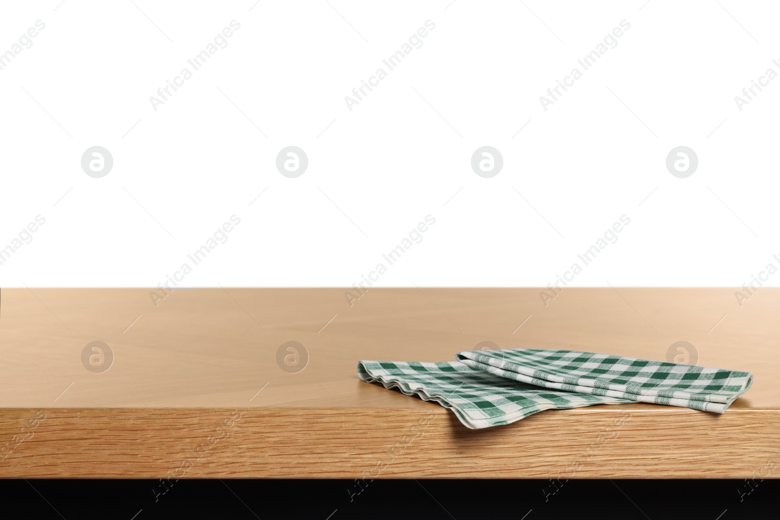 Photo of Checkered tablecloth on wooden table against white background