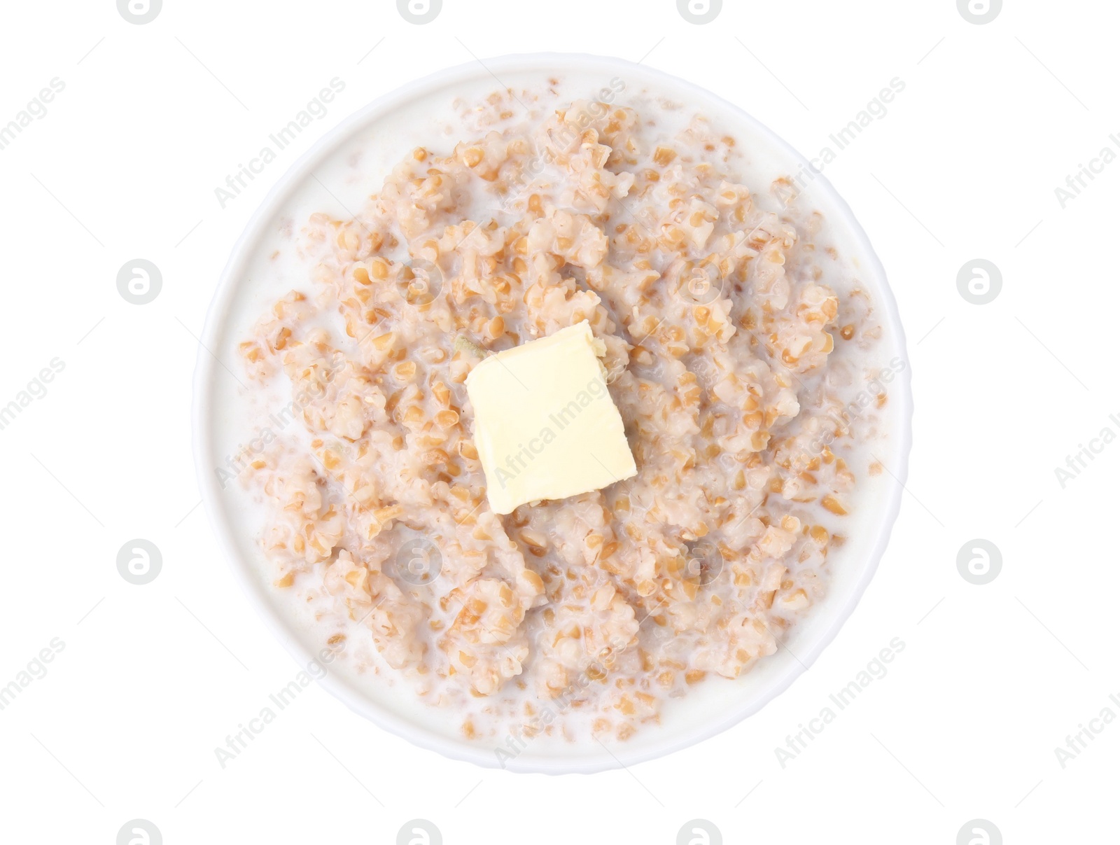 Photo of Tasty wheat porridge with milk and butter in bowl isolated on white, top view