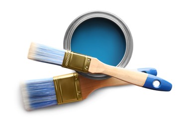 Photo of Can of blue paint and brushes on white background, top view