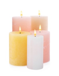 Set of burning wax candles on white background