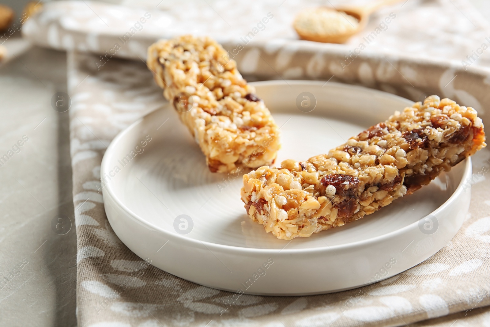 Photo of Plate with different homemade grain cereal bars on table. Healthy snack