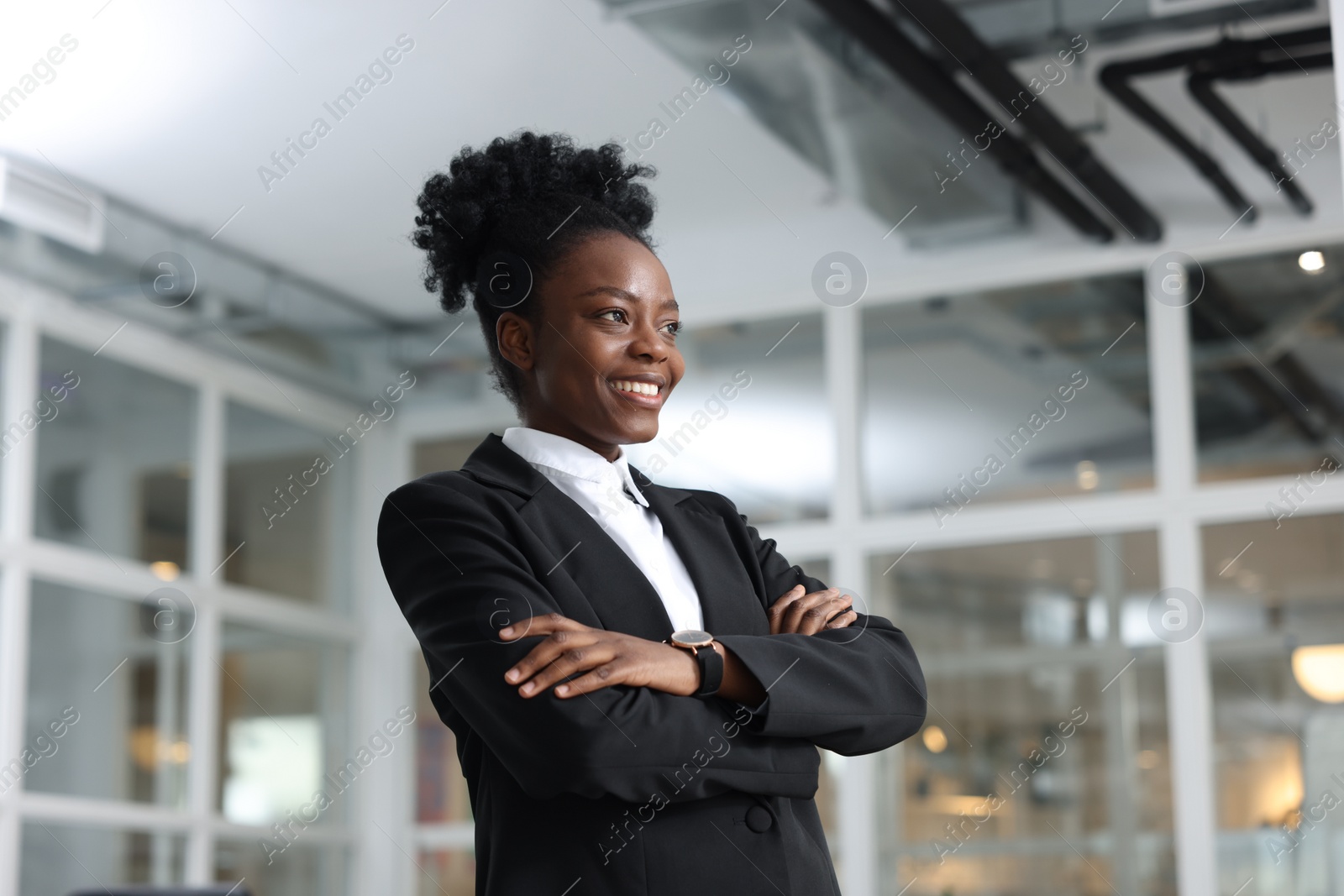 Photo of Happy woman with crossed arms in office. Lawyer, businesswoman, accountant or manager