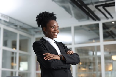 Happy woman with crossed arms in office. Lawyer, businesswoman, accountant or manager