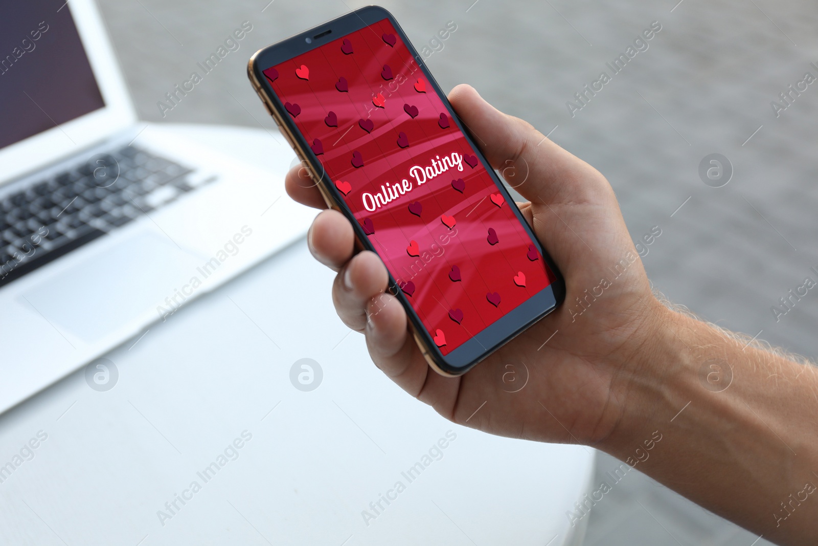 Image of Man visiting dating site via smartphone in outdoor cafe, closeup