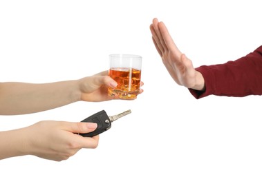 Photo of Man refusing alcoholic drink while woman suggesting him car keys and glass of whiskey on white background, closeup. Don't drink and drive concept