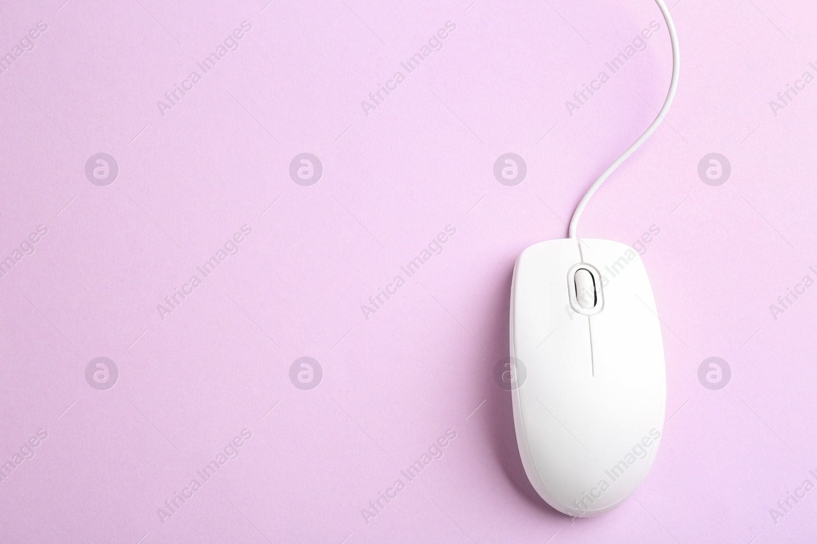 Photo of Modern wired optical mouse on lilac background, top view. Space for text