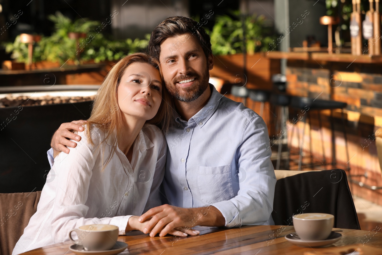 Photo of Romantic date. Lovely couple spending time together in cafe