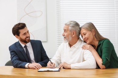 Notary consulting senior couple about Last Will and Testament in office