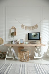 Photo of Stylish home office interior with comfortable workplace